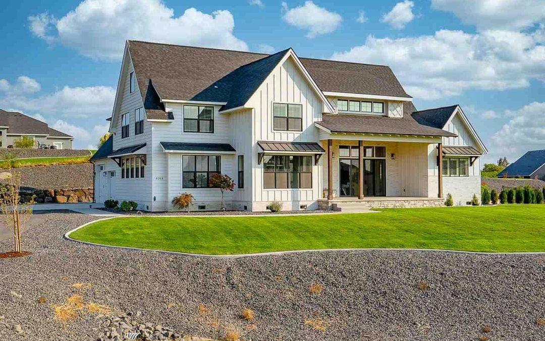 Kennewick, Washington Modern Farmhouse custom built for a family with a play loft, pool, garden, black windows, views from all rooms, built-in office, and barn doors on the pantry.
